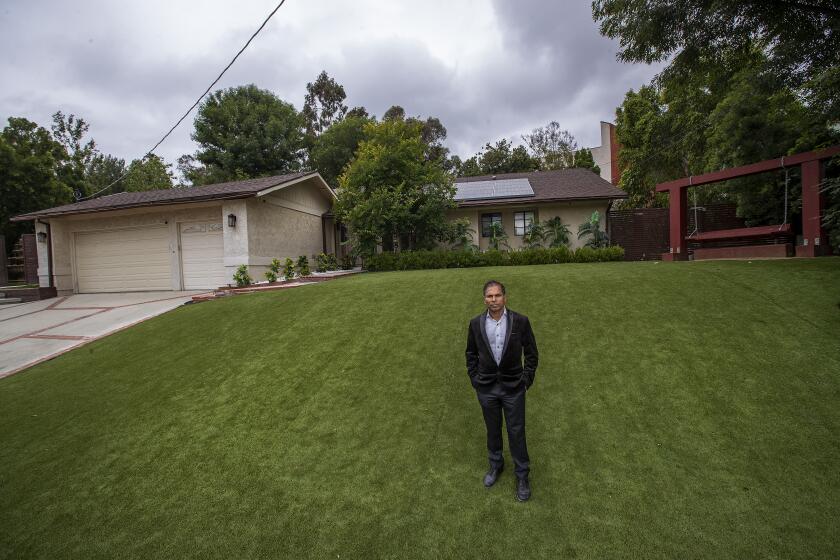 WOODLAND HILLS, CA-JUNE 5, 2023:Akhilesh Jha, a self taught developer, is photographed on a 16,700 square foot lot on Del Moreno Dr. in Woodland Hills that he plans to build a 67 unit apartment building on. The city of Los Angeles denied his project, saying that the current zoning doesn't allow apartments, but Jha filed a lawsuit against the city and won. (Mel Melcon / Los Angeles Times)