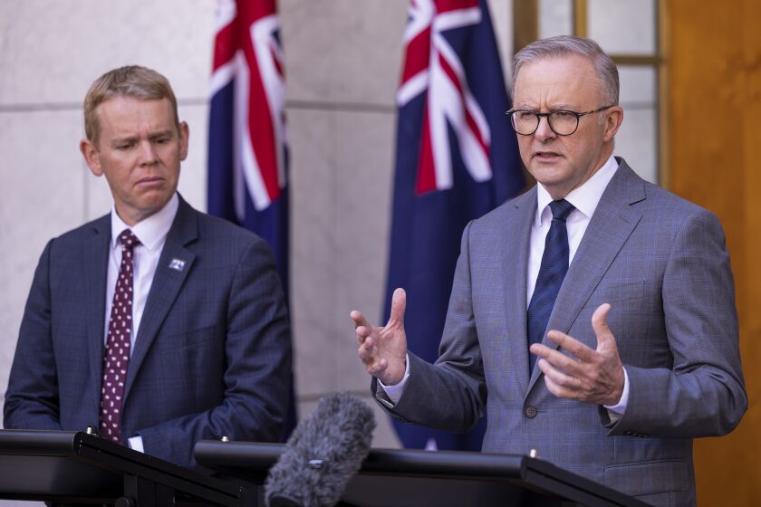 New Zealand Prime Minister Chris Hipkins, left, listens as Australian Prime Minister Anthony Albanese speaks during a joint press conference in Parliament House in Canberra, Australia, Tuesday, Feb. 7, 2023. (AP Photo/Hilary Wardhaugh)