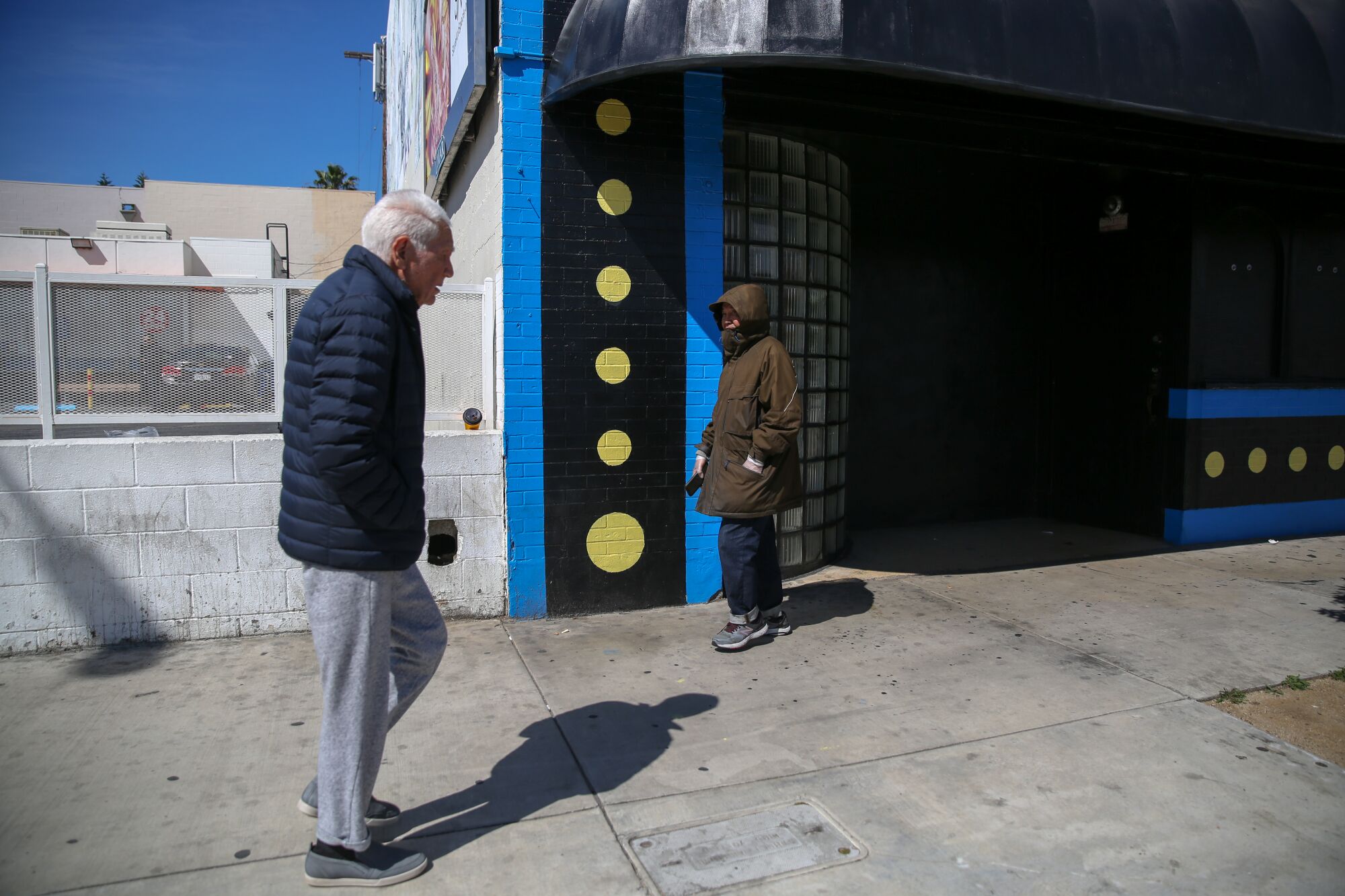 Ben Barcelona, right, on one of his daily walks through Koreatown, several days after Gov. Gavin Newsom ordered Californians to shelter at home.