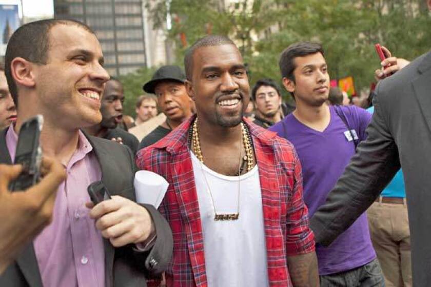 Musician Kanye West visits the "Occupy Wall Street" protests in Zuccotti Park on Monday.