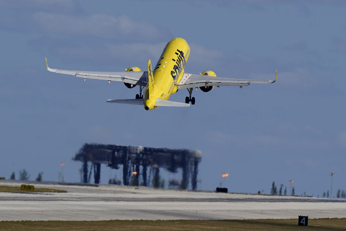 FILE - In this Jan. 19, 2021 file photo, a Spirit Airlines Airbus A320 takes off from Fort Lauderdale-Hollywood International Airport in Fort Lauderdale, Fla. The budget airline will get a chance to add flights at the busy airport in Newark, New Jersey, just outside New York City. The Transportation Department said Thursday that it will give coveted afternoon and evening runway rights to a low-cost airline. (AP Photo/Wilfredo Lee)