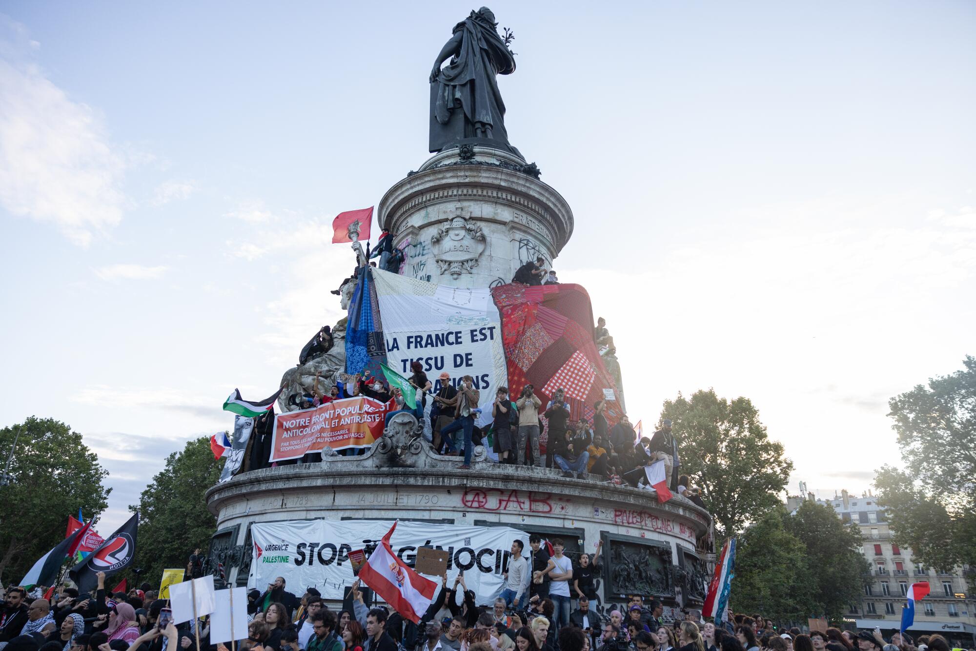 Supporters of the left wing union, New Popular Front, gather during a protest at the Place de la Republique.