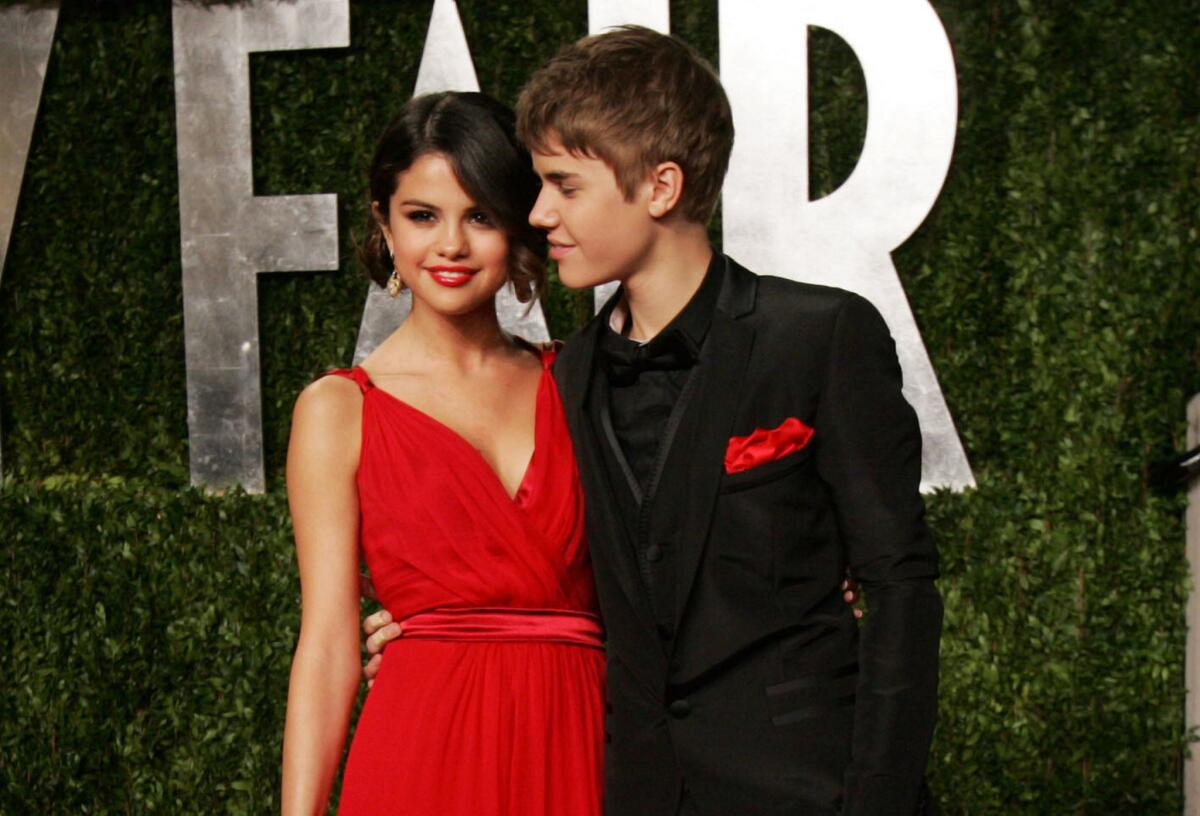 Selena Gomez and Justin Bieber step out together at the 2011 Vanity Fair Oscars party.