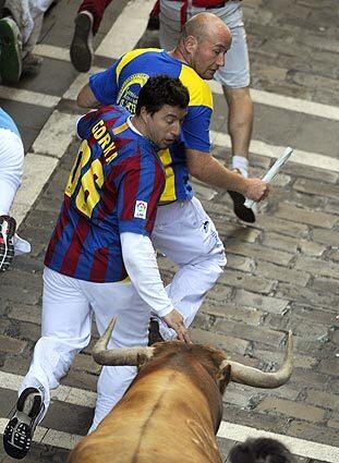Runners try to stay ahead of a bull on the fourth run of the San Fermin Festival in Pamplona, Spain.