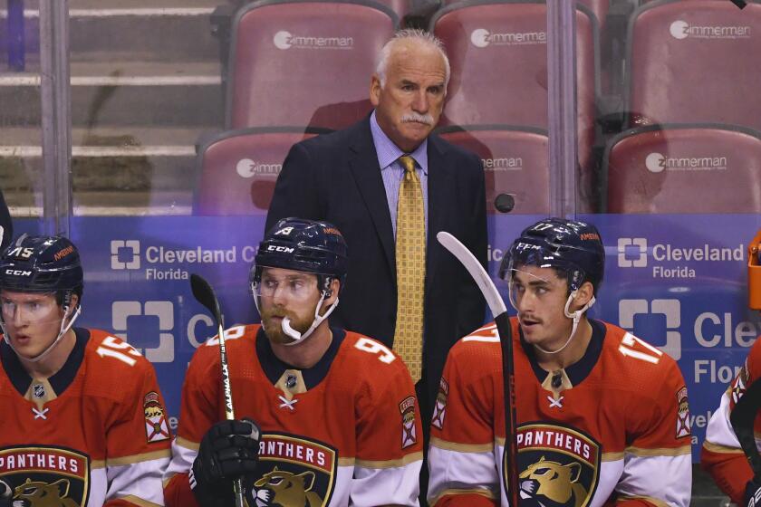 Florida Panthers head coach Joel Quenneville looks on from the bench during the first period of an NHL hockey game against the Colorado Avalanche, Tuesday, Oct. 21, 2021, in Sunrise, Fla. (AP Photo/Jim Rassol)