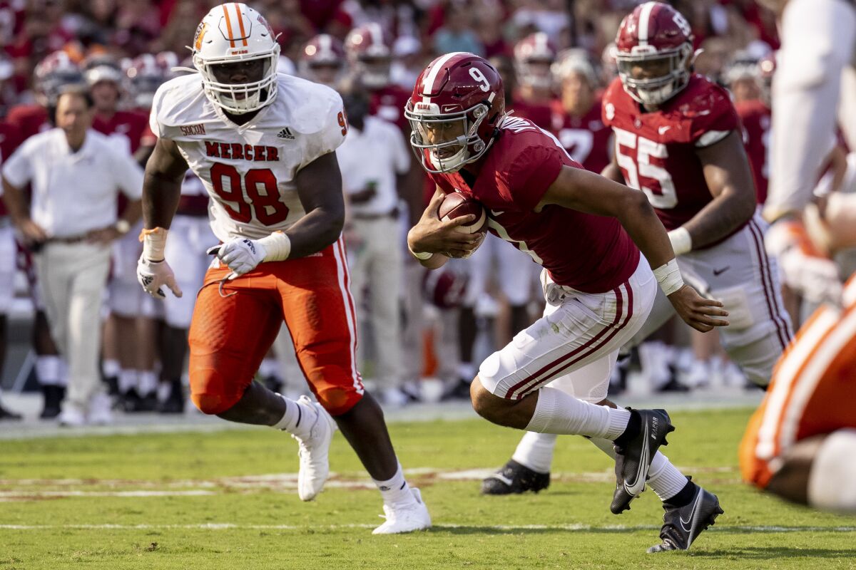 Alabama quarterback Bryce Young runs against Mercer during the first half Sept. 11, 2021.