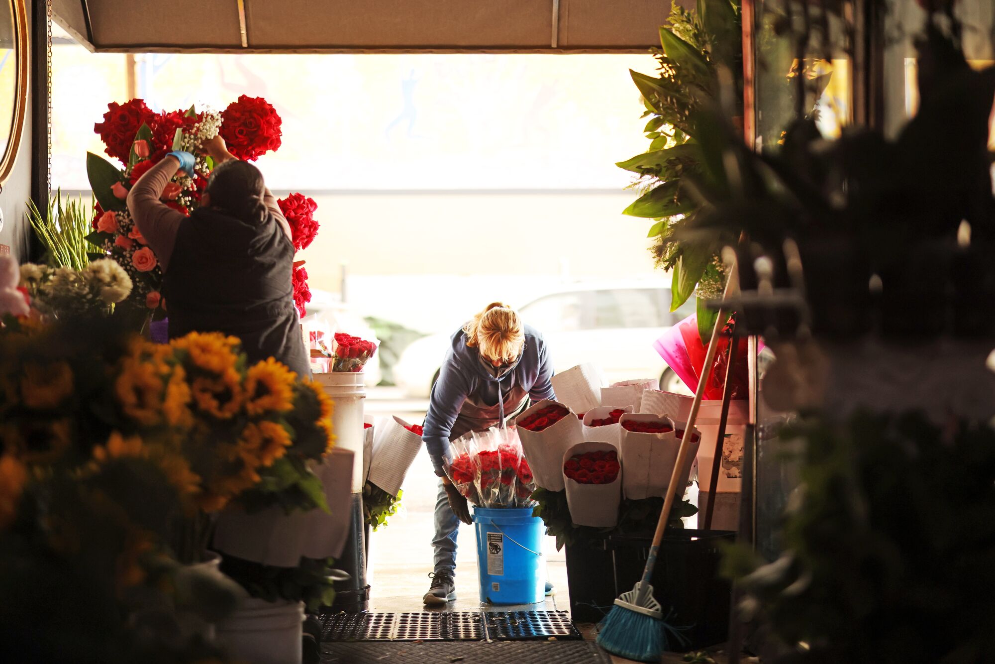 Adriana Gamez arranges the display at California Flowers.