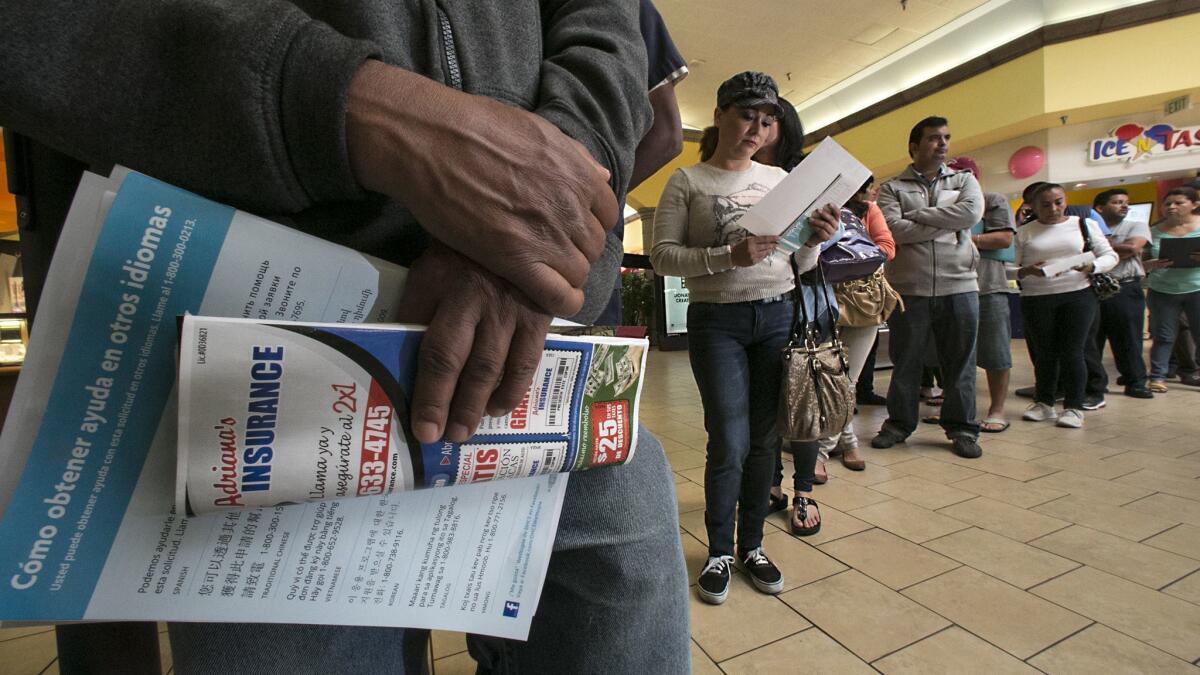 A Covered California enrollment line at the Panorama Mall in 2014. Enrollees' incomes were checked and, if qualified, they were signed up for Medi-Cal instead of a subsidized health plan.