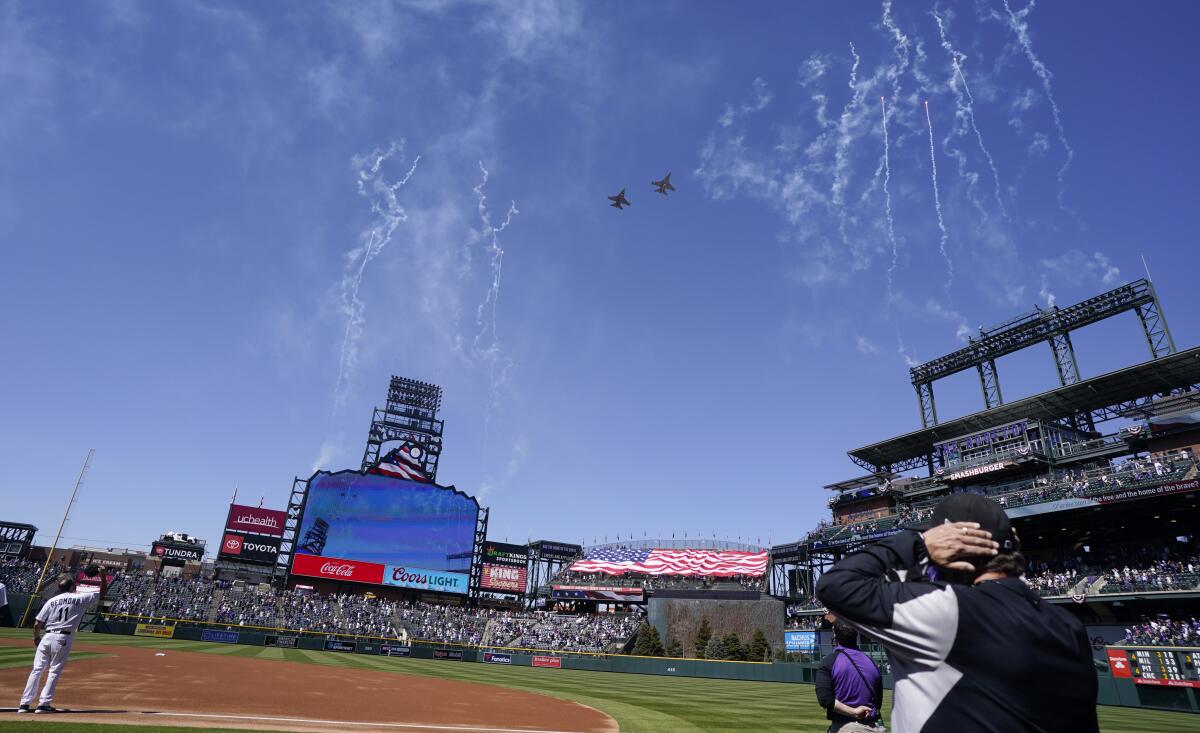 Two F-16 jets from fly over Coors Field before a game between the Dodgers and the Colorado Rockies.