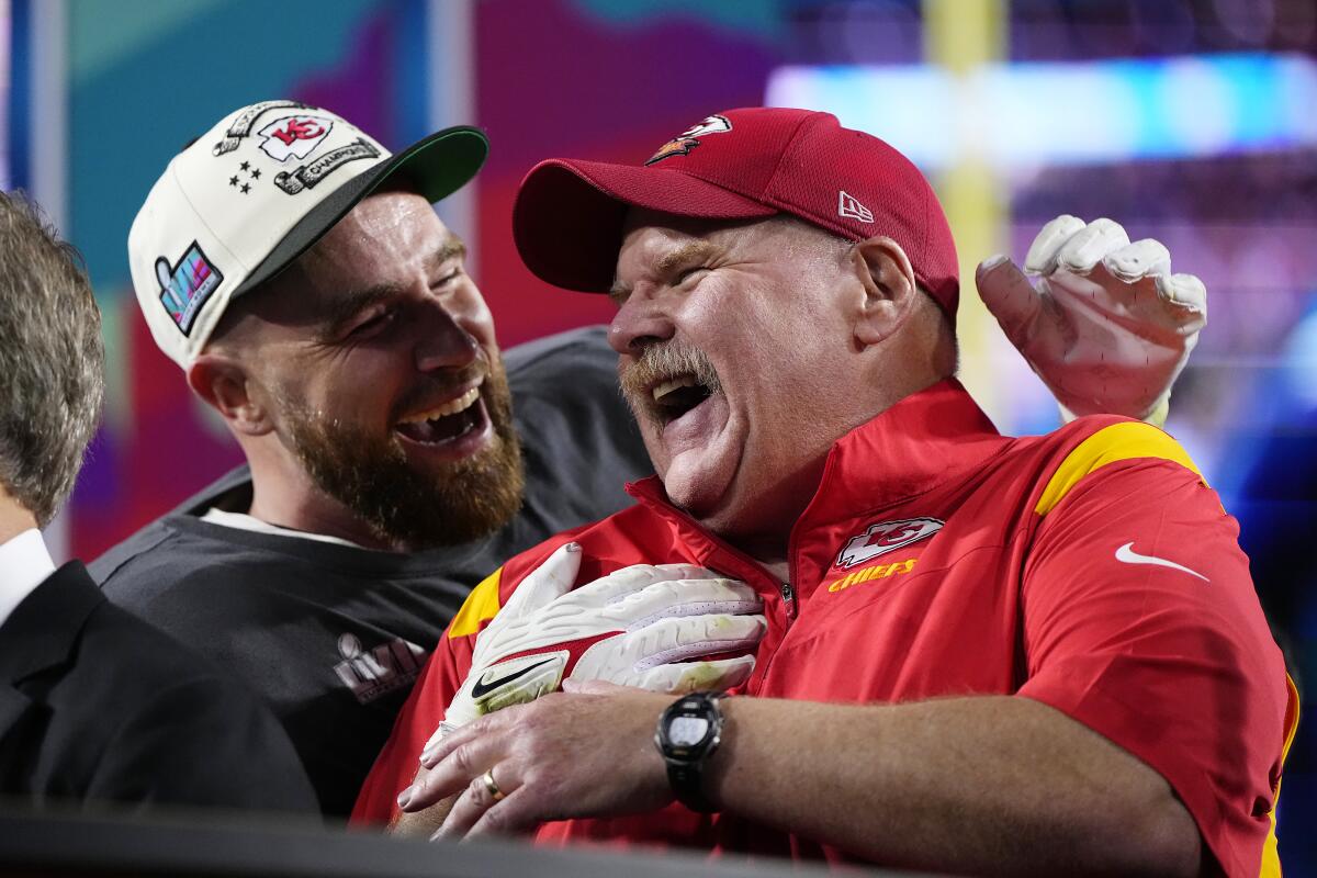 Kansas City Chiefs head coach Andy Reid and Travis Kelce laugh as they celebrate their Super Bowl win in 2023.