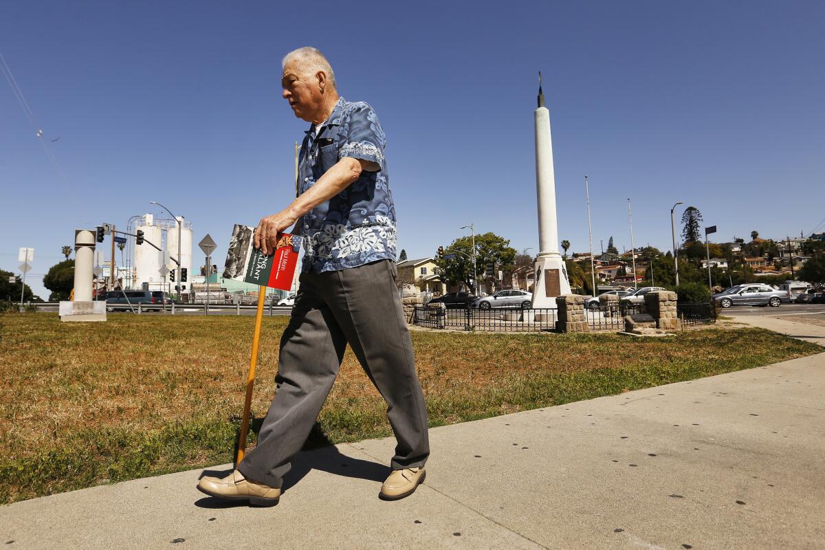 Eddie Morin, 75, son of Raul Morin, walks around the veterans' memorial at a five-point intersection in Boyle Heights.