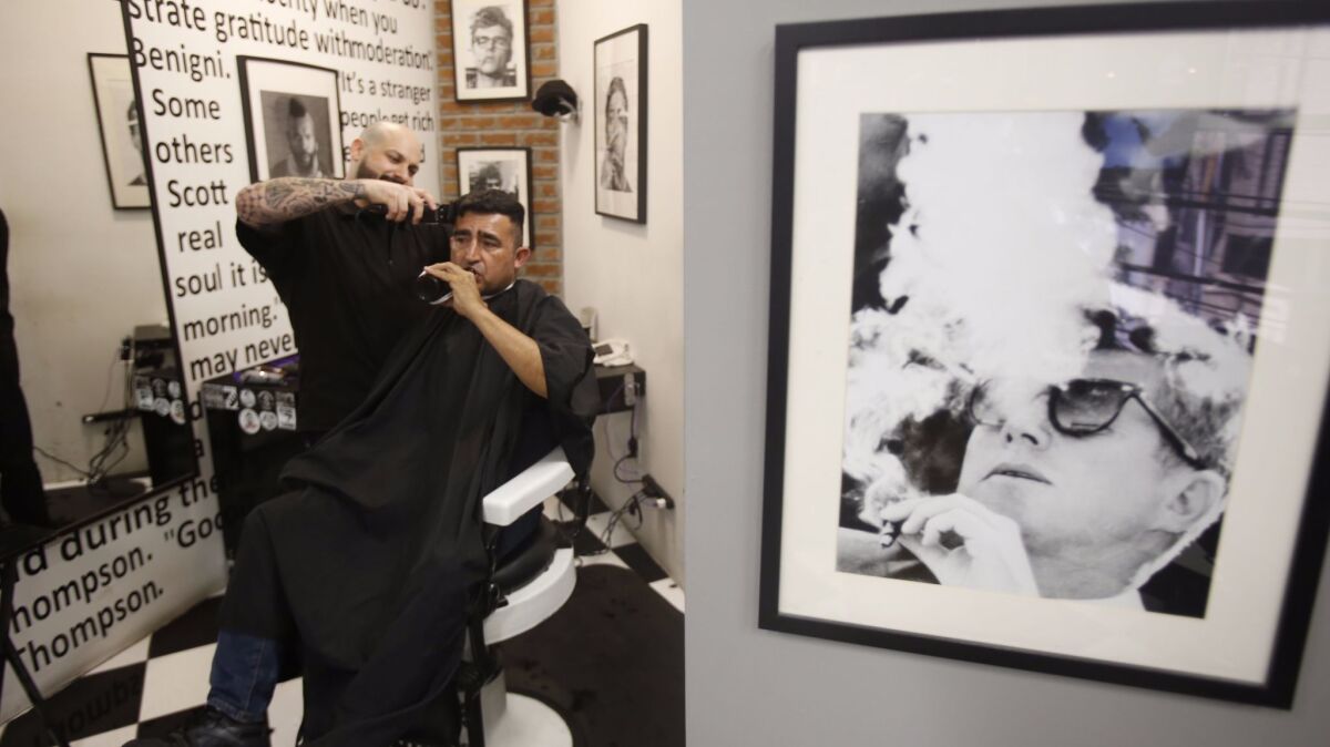 Barber Shalum Martinez trimming German Prado Lopez hair at The Barber Shop Mexico.