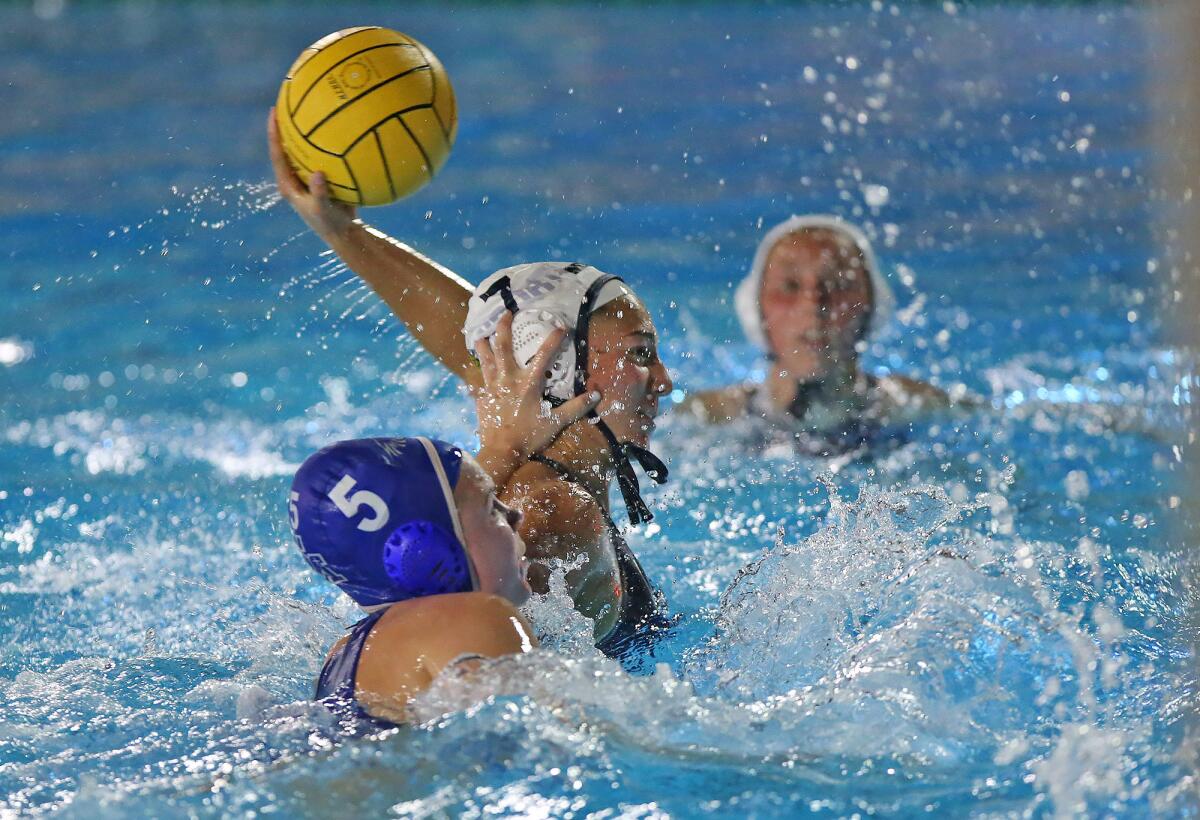 Newport Harbor’s Avery Montiel (7) gets a hand to the side of her head from Santa Margarita’s Savannah Burns (5) and manages to score during Thursday's CIF Southern Section Division 1 playoff opener at Saddleback College.