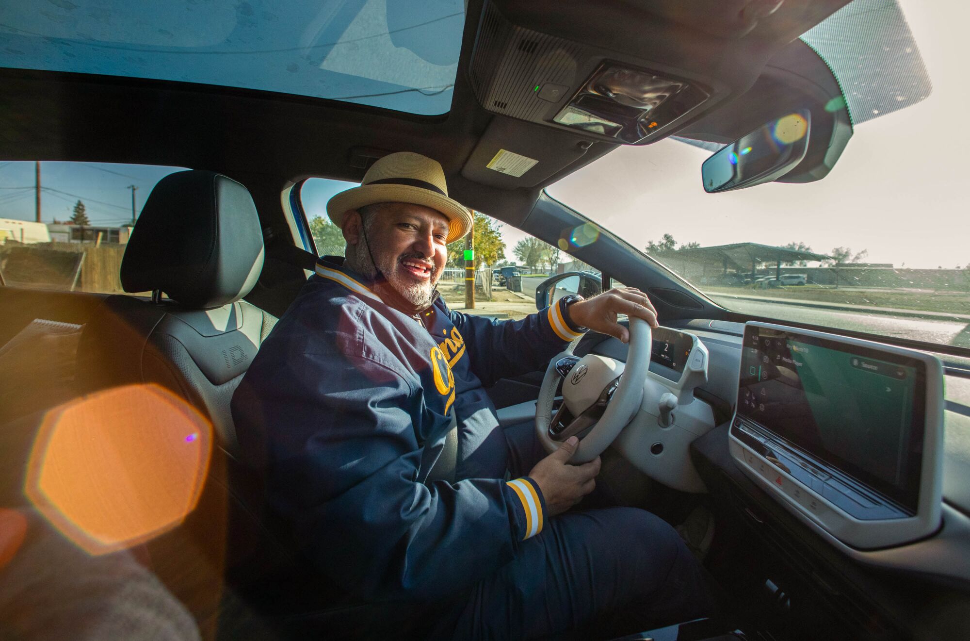 Huron Mayor Rey León smiles as he drives on the Green Raiteros electric vehicles. 