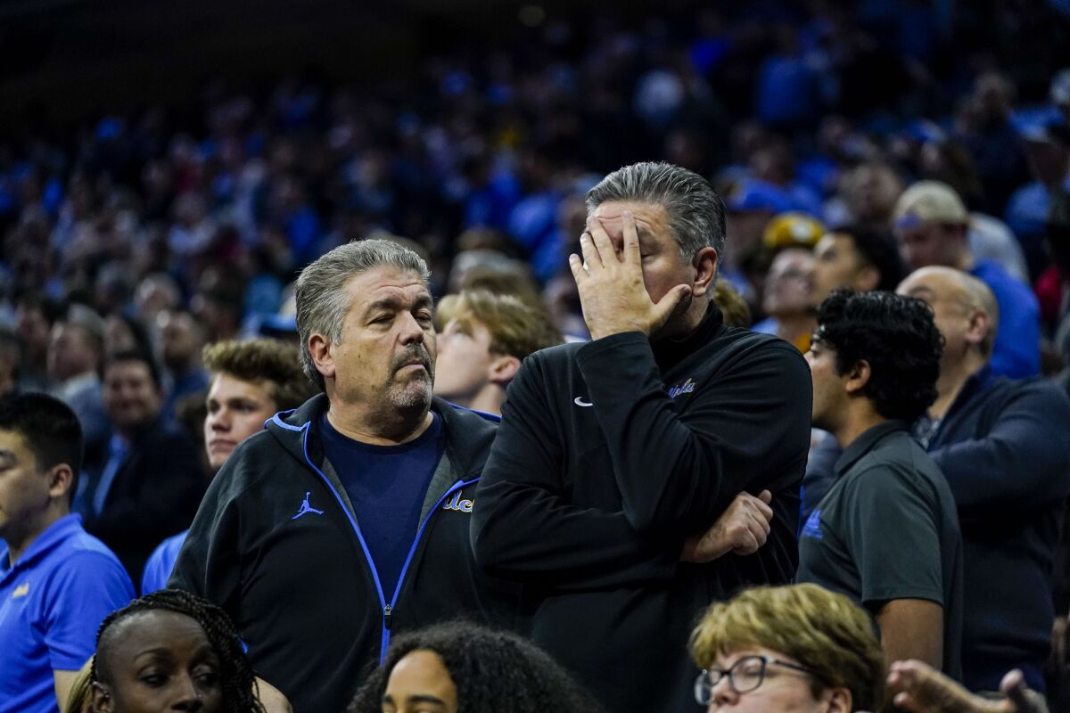 UCLA basketball fans react in the final seconds of the Bruins' Sweet 16 loss to North Carolina.
