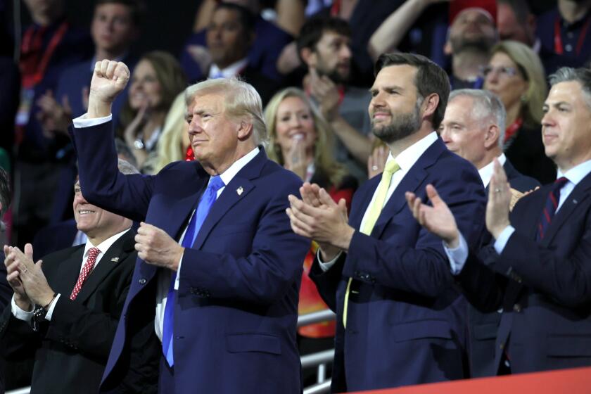 MILWAUKEE, WI JULY 16, 2024 -- Republican presidential candidate former President Donald Trump, left, and Republican vice presidential candidate Sen. JD Vance react to a speech during the Republican National Convention on Tuesday, July 16, 2024. (Robert Gauthier / Los Angeles Times)