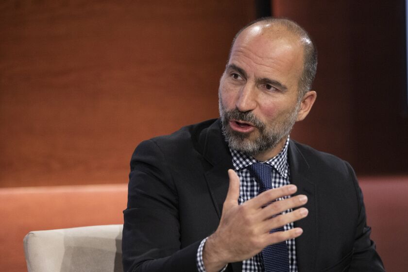 FILE - In this Wednesday, Sept. 25, 2019, file photo Dara Khosrowshahi, CEO of Uber, speaks at the Bloomberg Global Business Forum in New York. Uber will begin cramming more services into its ride-hailing app as it explores ways to generate more revenue and finally turn a profit. The makeover announced Thursday, Sept. 26, will include force-feeding its food delivery service, "Eats," into the Uber app that millions of people use to summon a ride. (AP Photo/Mark Lennihan, File)
