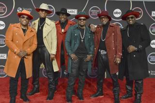 New Edition's Michael Bivins, Ronnie Devoe, Bobby Brown, Ricky Bell, Ralph Tresvant and Johnny Gill pose on a red carpet
