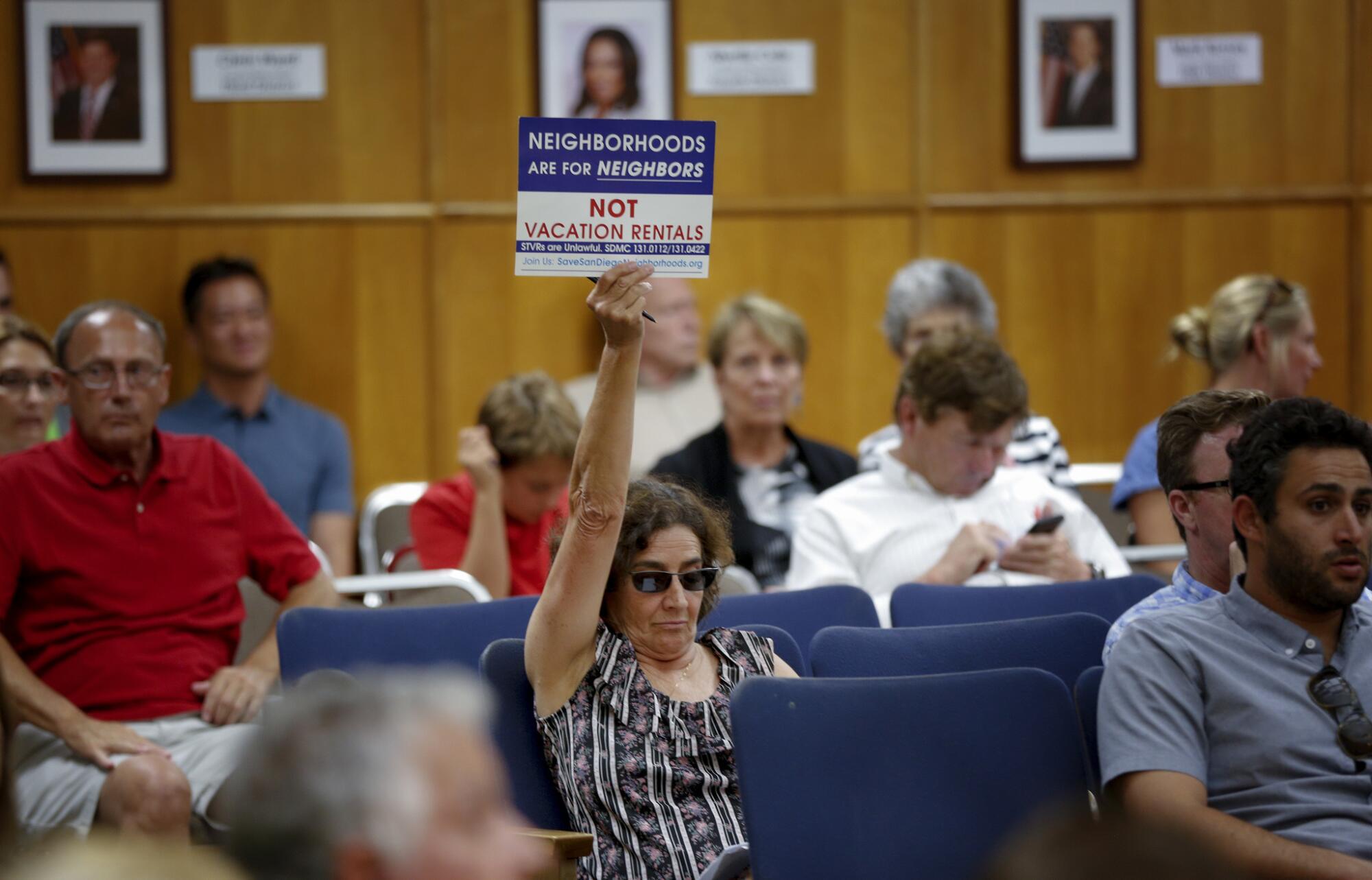 Dawn Sassi from University Heights, waved her sign showing her opposition for vacation rentals in San Diego.