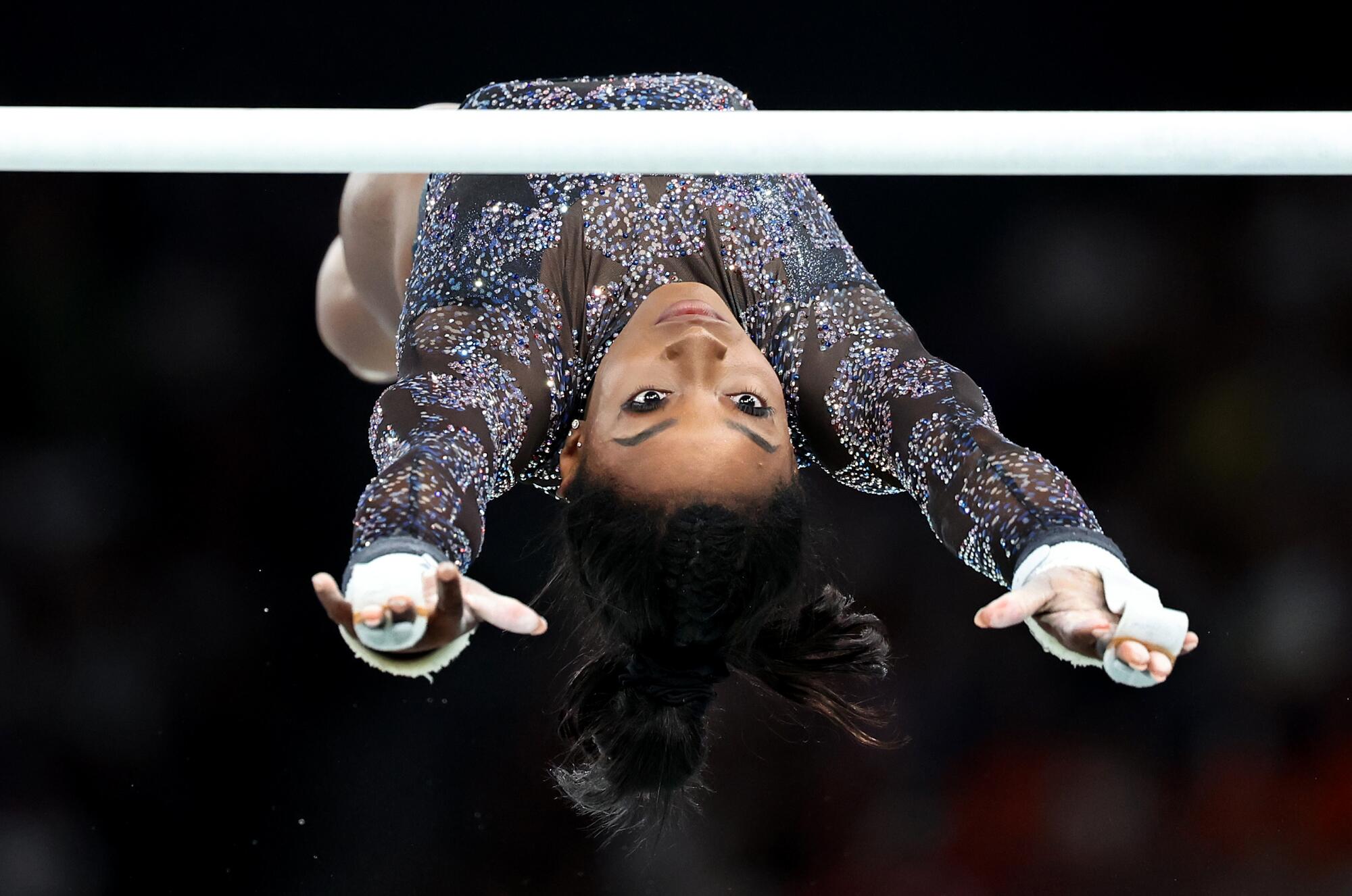 USA's Simone Biles competes on the uneven bars during qualifying for women's team gymnastics at the 2024 Olympics in Paris.