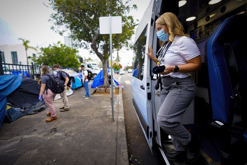 San Diego, CA - September 30: On Friday, Sept. 30, 2022 in downtown San Diego, CA., Laine Goettsch, lead peer navigator steps out of the mobile health clinic van. Goettsch along with a team of health professionals from Healthcare in Action were on hand to offer medical services to individuals at a homeless encampment on F Street. (Nelvin C. Cepeda / The San Diego Union-Tribune)