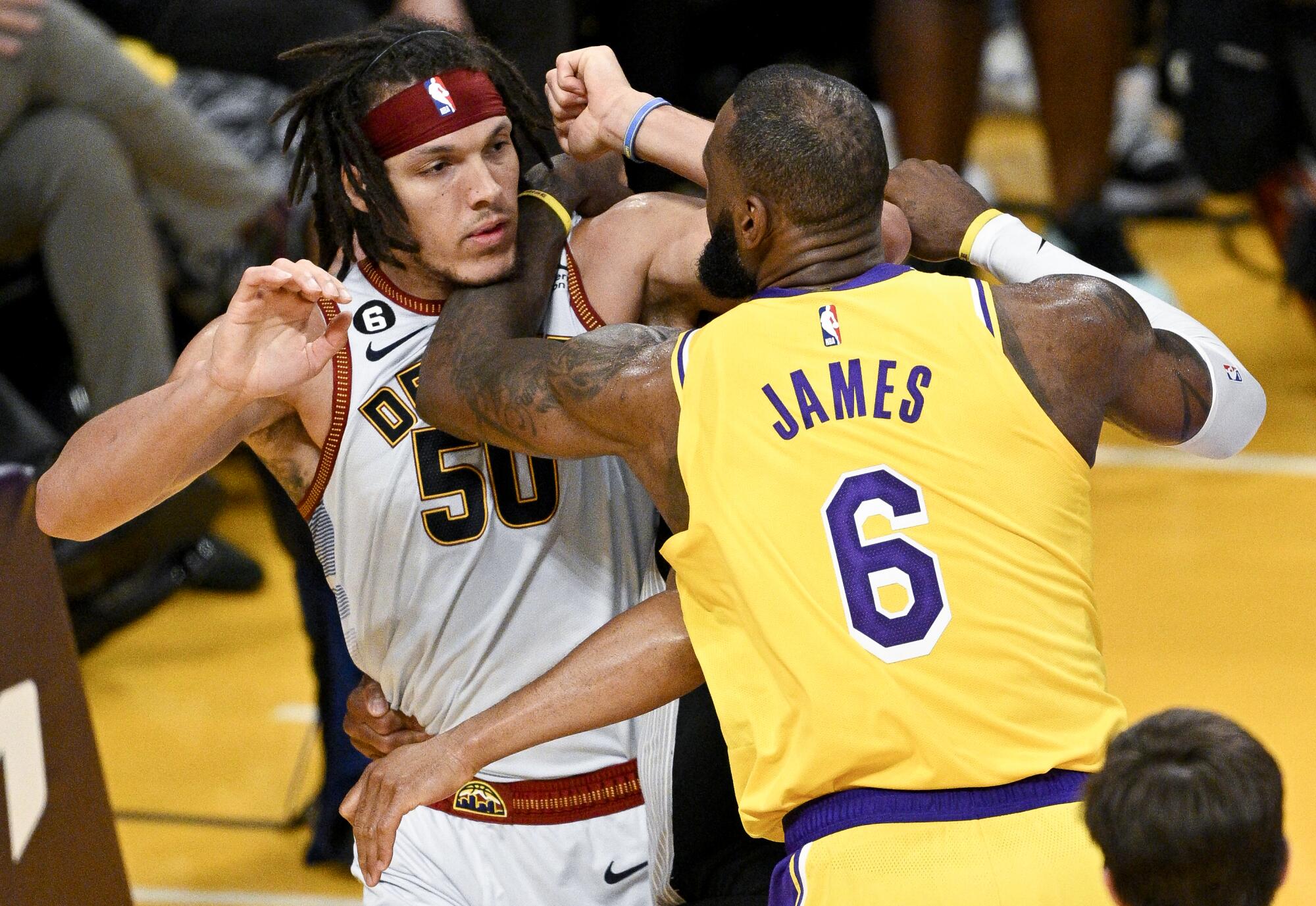 Lakers forward LeBron James, right, and Denver Nuggets forward Aaron Gordon get into a scuffle.