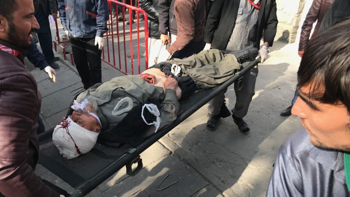 An injured man is taken to a hospital after the Kabul blast.