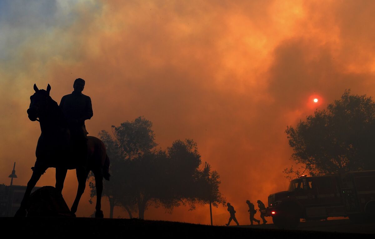 Smoke clouds the sky as the Easy fire burns in Simi Valley