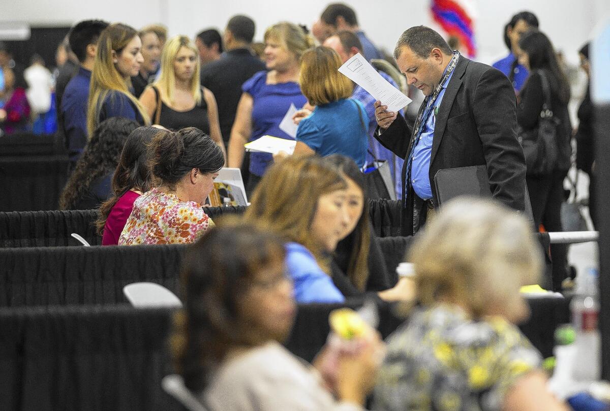Job seekers attend a job fair at the Anaheim Convention Center in June.
