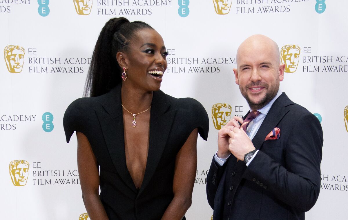 Red carpet hosts Tom Allen and AJ Odudu pose for photographers during a photo call for the 2022 British Academy Film Nominations, at Bafta Headquarters, central London, Thursday, Feb. 3, 2022. (Photo by Joel C Ryan/Invision/AP)
