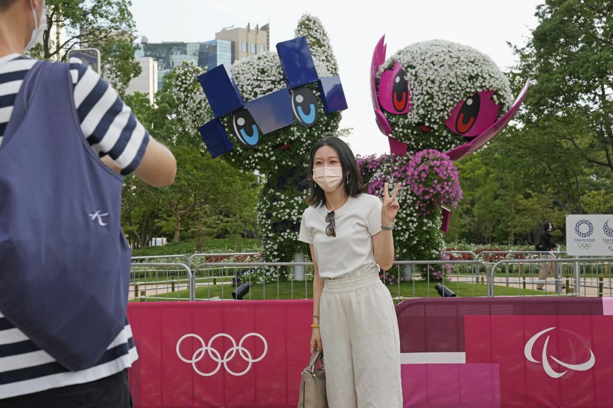 A couple take a photo at Symbol Promenade Park in July. 