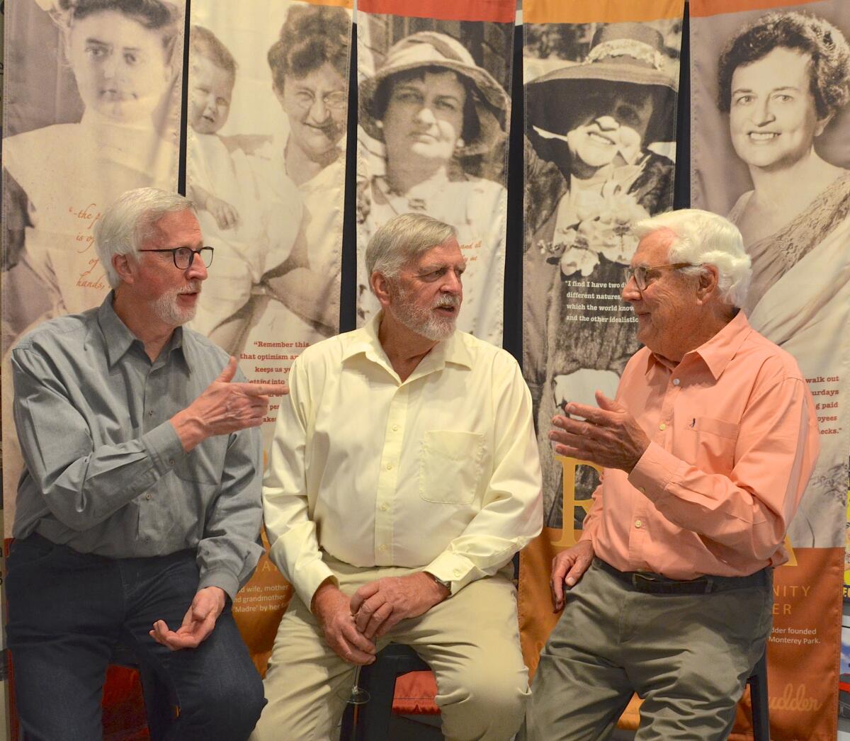 Kent, Craig and John Scudder compare memories with a vintage photo collection at Balboa Island Museum.