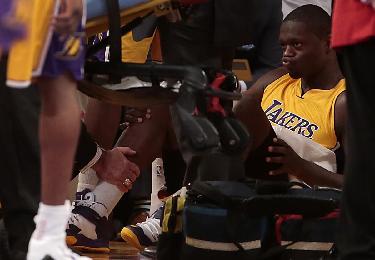 Lakers rookie Julius Randle suffered a fractured right tibia Oct. 28 during the fourth quarter of his NBA debut. The Lakers lost to the Houston Rockets, 108-90.