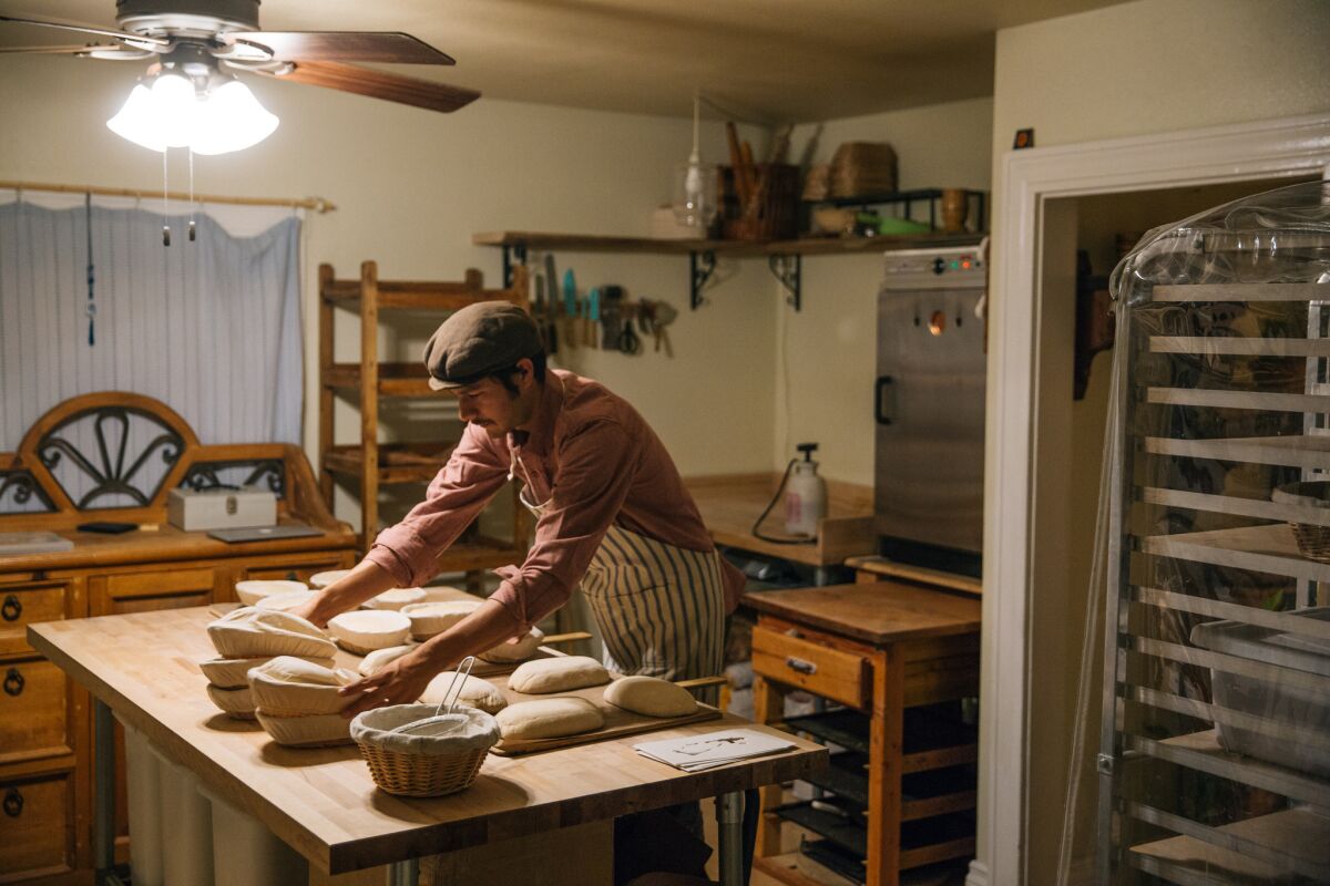 Baker Arturo Enciso forms dough at his home bakery, Gusto Bread.