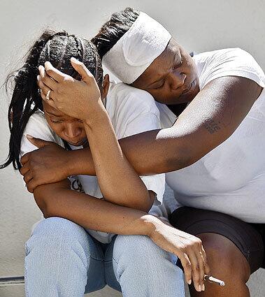 Tyisha Player, whose husband was killed by Sheriff's Department deputies, is comforted by her friend Talonnie Smith near the shooting scene.