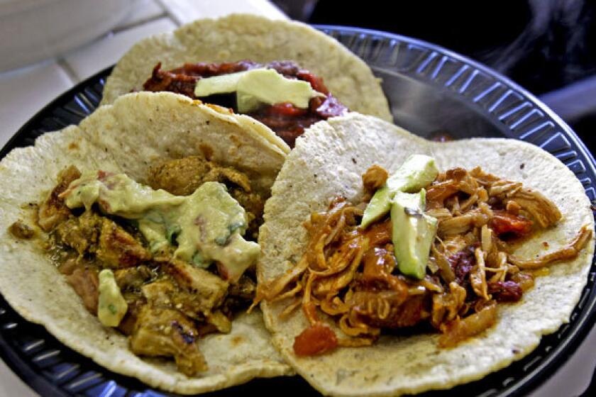 Pork in salsa verde, left, beef steak in pimento, rear, and tinga chicken are served on freshly made tortillas.