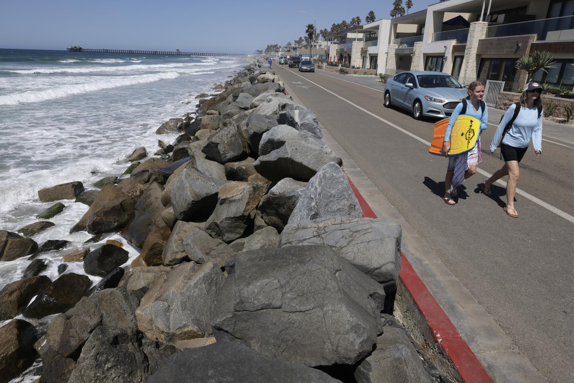 People walk along the southern end of the Strand in Oceanside.