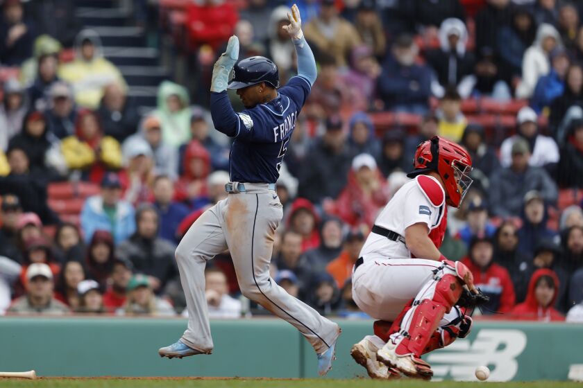 Tampa Bay Rays' Wander Franco (5) scores behind Boston Red Sox's Reese McGuire on a sacrifice fly by Harold Ramirez during the fifth inning of the first baseball game of a doubleheader, Saturday, June 3, 2023, in Boston. (AP Photo/Michael Dwyer)