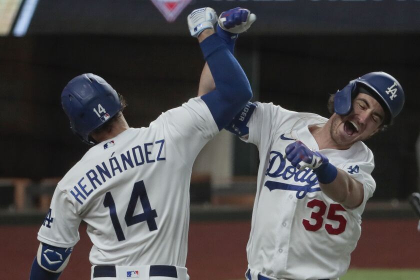 Dodgers' Cody Bellinger, right, celebrates with teammate Kiké Hernandez after hitting a home run 