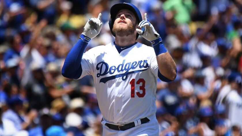 Dodgers' Max Muncy celebrates his solo home run against the Chicago Cubs as he crosses the home plate in the third inning at Dodger Stadium on Thursday.