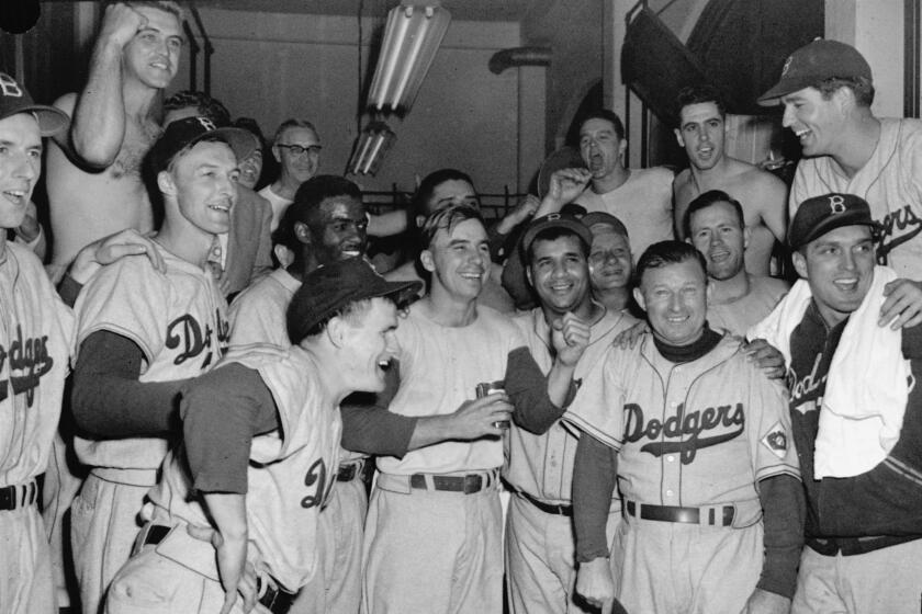 FILE - In this September 1951 file photo, Brooklyn Dodgers whoop it up in their dressing room.