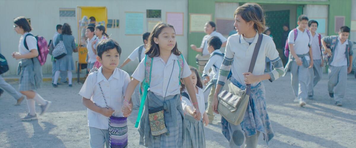 Mía Fernanda Solís (center) plays Lupita in "Radical."