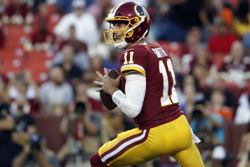 Washington Redskins quarterback Alex Smith (11) looks to pass during the first half of a preseason NFL football game against the Denver Broncos, Friday, Aug. 24, 2018, in Landover, Md. (AP Photo/Alex Brandon)