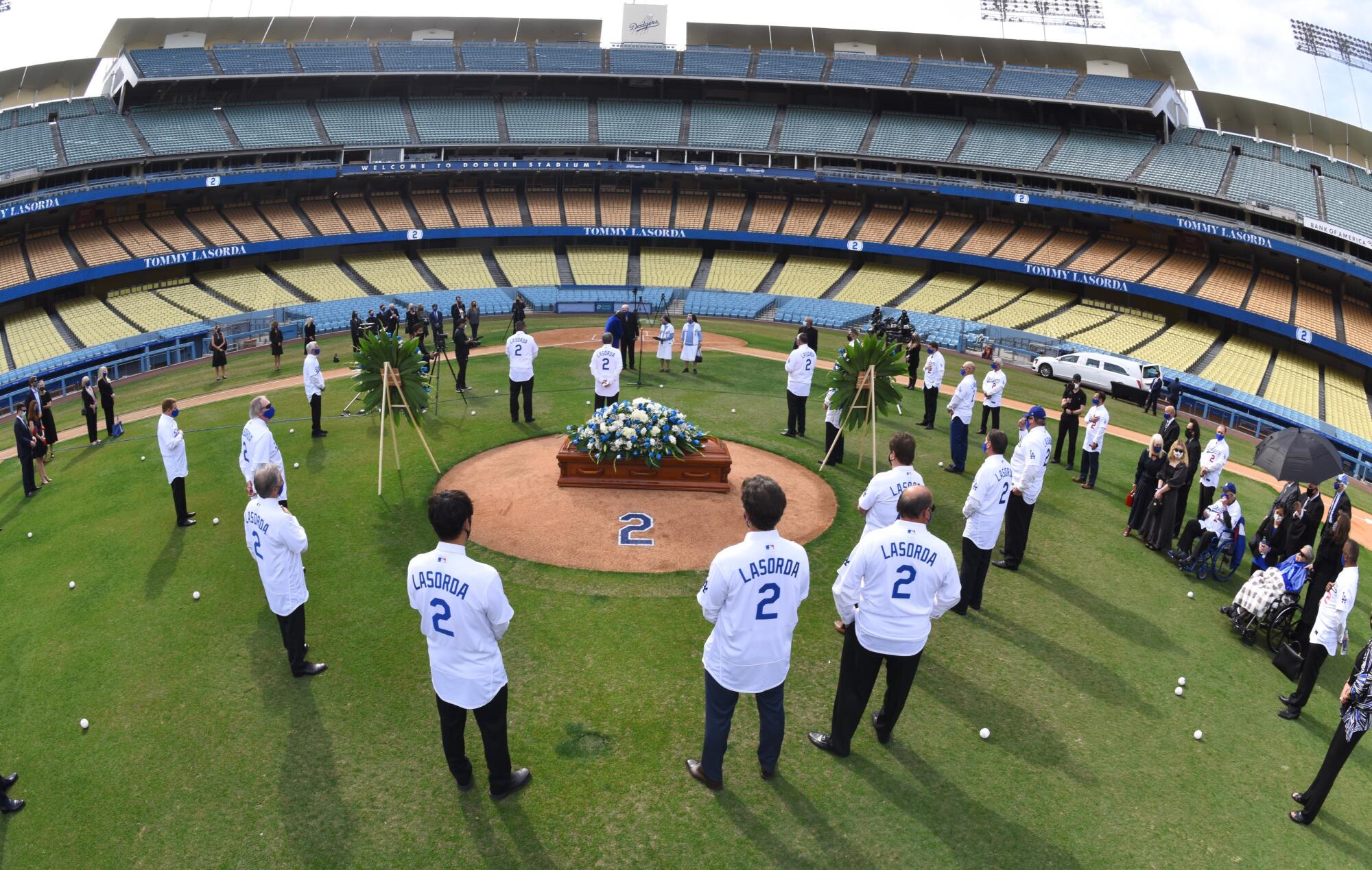 Family and friends gather around Tommy Lasorda's casket during a celebration of life ceremony for the former Dodger manager.