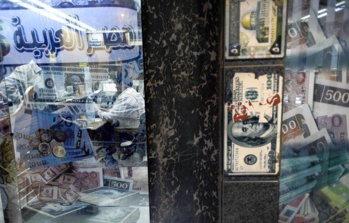 An Egyptian man exchanges foreign currency in Cairo. A Cabinet shake-up in Egypt sought to soothe concerns about President Mohamed Morsi's handling of the economy.
