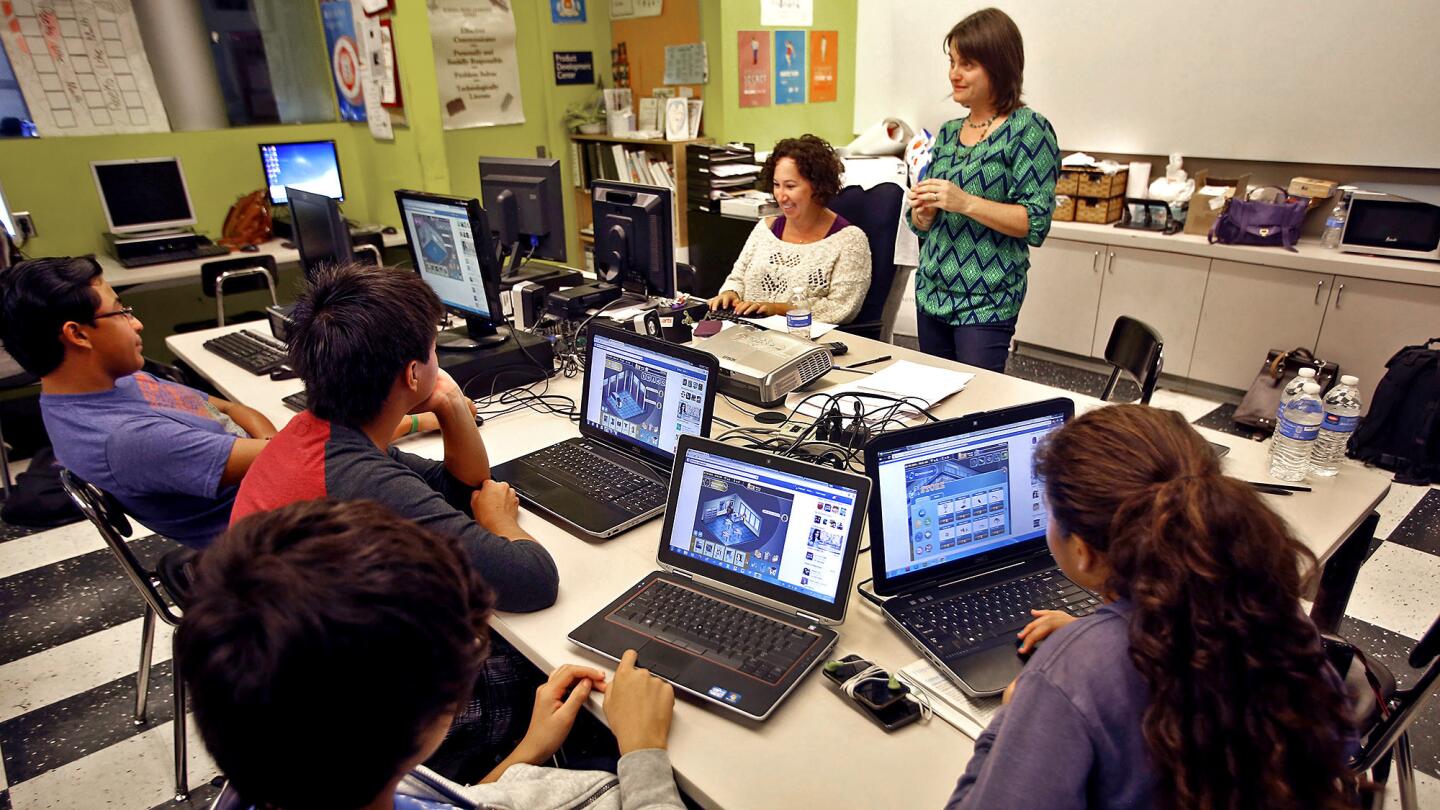 Zoe Blumberg Corwin talks with students at Foshay Learning Center about "Mission Admission," a video game developed by USC experts that helps students learn about the college application process.