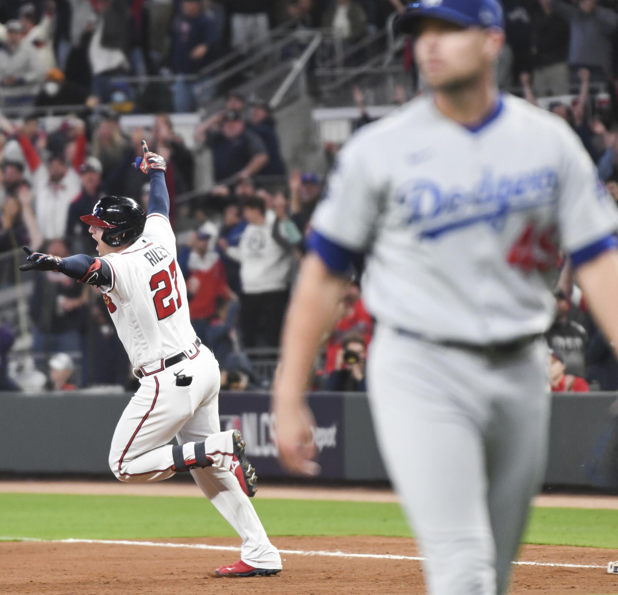 Braves' Austin Riley celebrates after hitting a walk-off RBI single off Dodgers relief pitcher Blake Treinen