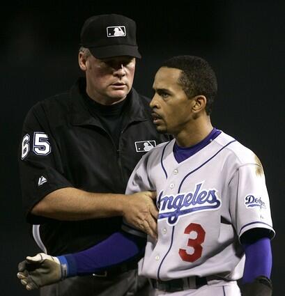 Dodgers' Julio Lugo is restrained by second base umpire Ted Barrett after being ejected.