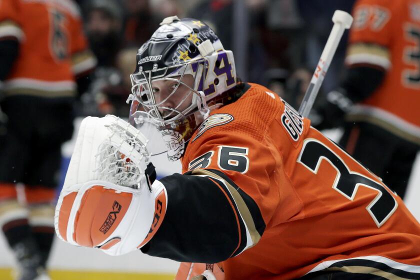 Anaheim Ducks goaltender John Gibson wears a Kobe Bryant tribute helmet during warmups before an NHL hockey game against the Tampa Bay Lightning in Anaheim, Calif., Friday, Jan. 31, 2020. Gibson is wearing a Kobe Bryant tribute helmet which features the Nos. 8 and 24, and a silhouette of Bryant and his daughter, Gianna, on the back, surrounded by the names of the seven other victims of Sunday's helicopter crash. (AP Photo/Alex Gallardo)