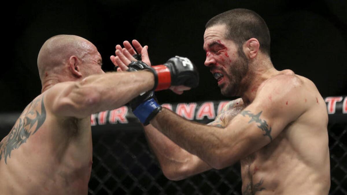 Donald Cerrone, left, battles Matt Brown during their bout at UFC 206 in Toronto.